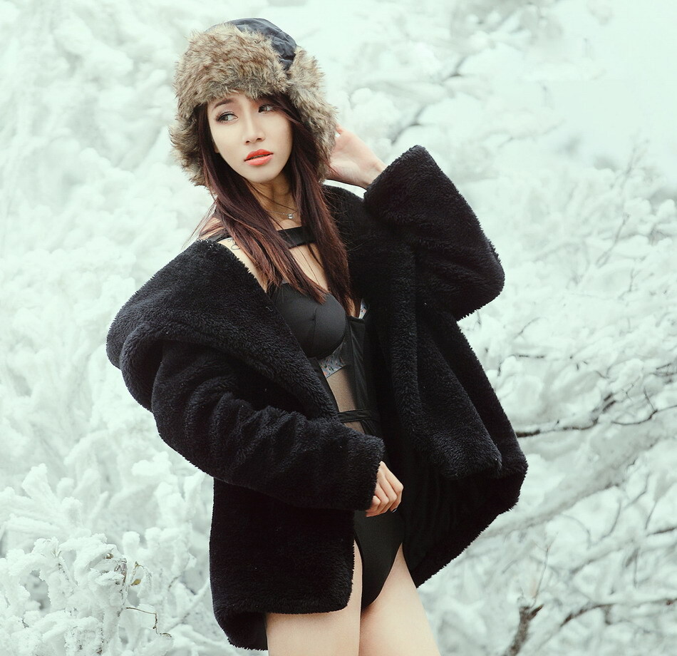 Beautiful girl shows her body in ice and snow